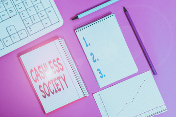 Word writing text Cashless Society. Business photo showcasing financial transactions are executed in electronic format Writing equipments and computer stuffs placed above colored plain table