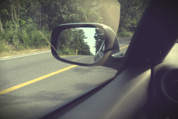 Landscape in the side view mirror of a car, on road countryside, natural