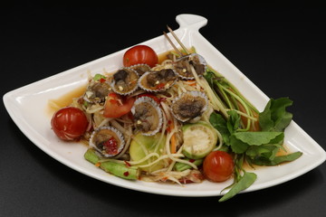 Somtum (Thai spicy salad) with scallop and vegetable in white plate
