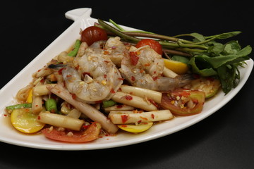Thai spicy salad with raw prawn in white dish