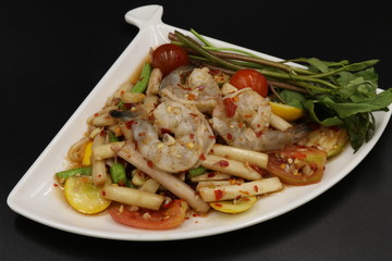 Thai spicy salad with raw prawn in white dish