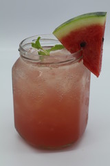 Fresh watermelon juice in glass with watermelon slice on top
