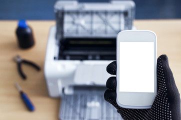 Call to printer repair service mockup. Blank screen mobile phone and broken printer on the table.