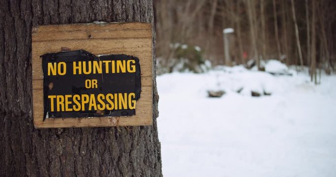 No hunting or trespassing sign nailed to a tree