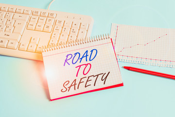 Text sign showing Road To Safety. Business photo showcasing Secure travel protect yourself and others Warning Caution Paper blue desk computer keyboard office study notebook chart numbers memo