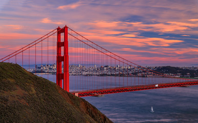 Fototapeta na wymiar Panorama of the Golden Gate bridge with the Marin Headlands and San Francisco skyline at colorful sunset, California