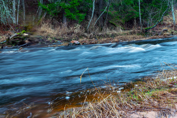 Fototapeta premium abstract blurry water texture, a steep river in the evening chair, photographed using the long exposure method