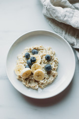 Healthy Breakfast, Blueberry Oatmeal on marble background with copy space