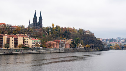 Fototapeta na wymiar Fort Vysehrad with cathedral of Saint Peter and Saint Paul near river Vltava on a cloudy day in autumn