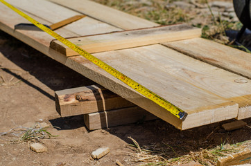 Fototapeta premium yellow measuring tape measures the formwork boards