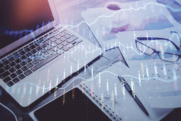 Stock market graph and table with computer background. Double exposure. Concept of financial analysis.
