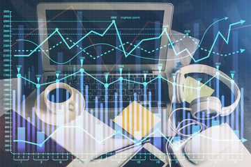 Double exposure of chart and financial info and work space with computer background. Concept of international online trading.