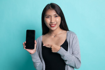 Young Asian woman point to mobile phone.