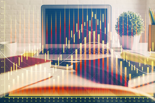 Financial graph colorful drawing and table with computer on background. Double exposure. Concept of international markets.