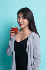 Fototapeta premium Young Asian woman drink tomato juice.
