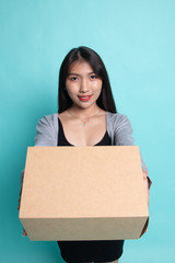 Delivery, relocation and unpacking.  young asian woman holding cardboard box.