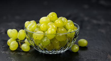 Slate slab with White Grapes (selective focus; close-up shot)