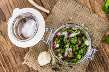 Chimichurri on an old wooden table (selective focus)
