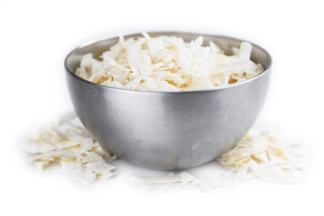 Coconut Chips isolated on white background (selective focus; close-up shot)