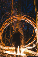 burning bonfire with soft glowing flame and sparkles flying all around. relaxing and enjoying the...