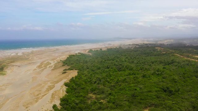 The Sand Dunes of Paoay, Ilocos norte, Philippines. Landscape with trees and sand hills near the ocean. Summer and travel vacation concept.