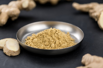 Some fresh Ginger Powder (selective focus; close-up shot)