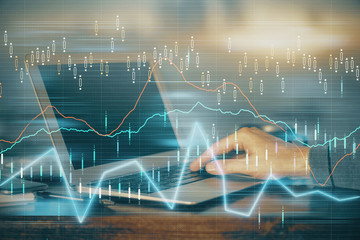 Multi exposure of stock market chart with man working on computer on background. Concept of financial analysis.