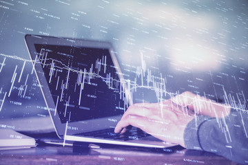 Multi exposure of stock market chart with man working on computer on background. Concept of financial analysis.