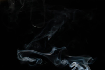Abstract smoke background with copy space on black background. Blue-white smoke rising from the incense stick