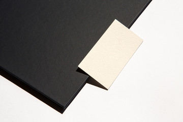 white business card on black folder