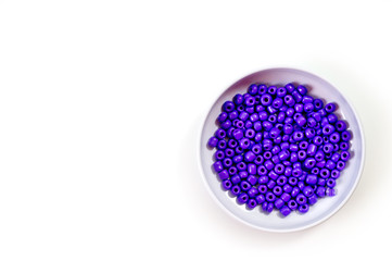 Round purple beads for making jewelry shot large on a white background