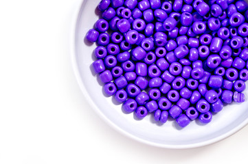 Round purple beads for making jewelry shot large on a white background
