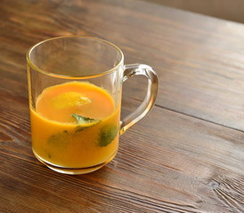 Sea buckthorn tea with lemon, honey and mint, copy space