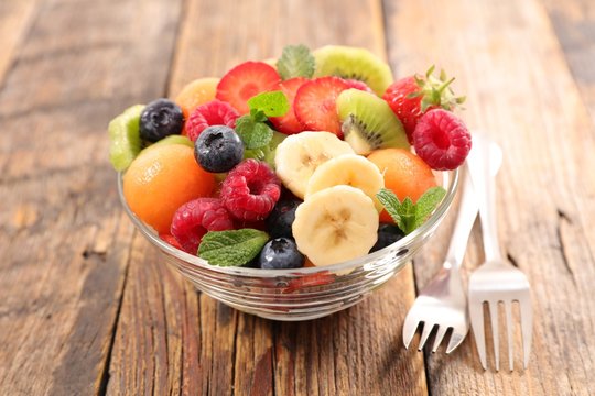 fresh fruit salad with banana, melon and berry