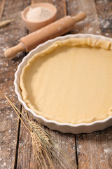 raw dough with rolling pin and flour
