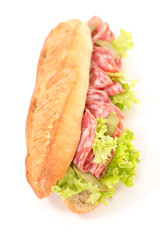 baguette with salami and lettuce isolated on white background