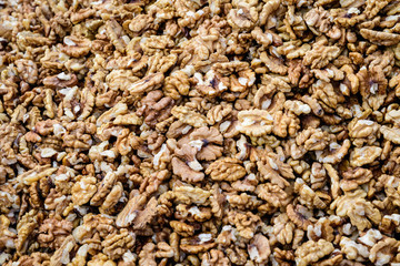Large group of fresh walnut kernels sold at a spice food market, organic food background