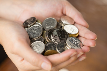 Bunch of Philippines peso coins on woman's hand