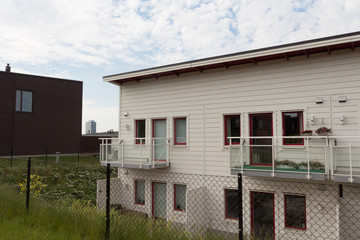 Residential area, two-storey wooden blocks of apartments on a summer sunny day. Sollentuna municipality, Stockholm, Sweden. Swedish style wooden housing