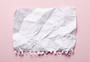 Crumpled paper on a pink background. Place for text. Idea concept.