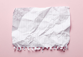 Obraz premium Crumpled paper on a pink background. Place for text. Idea concept.