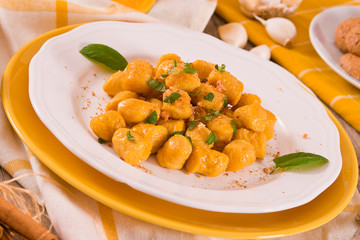 Pumpkin gnocchi with grated amaretti cookies.	