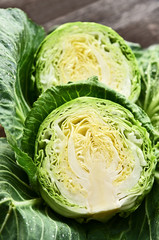 Obraz premium Colorful of cabbage cut half with water drop on wooden background.