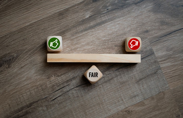 Cubes and dice with thumbs up and down fair yes or no on wooden background