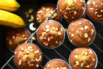 A lot of banana muffin or banana cup cake topping with cashew nut