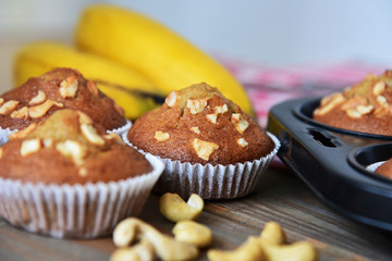 A lot of banana muffin or banana cup cake topping with cashew nut