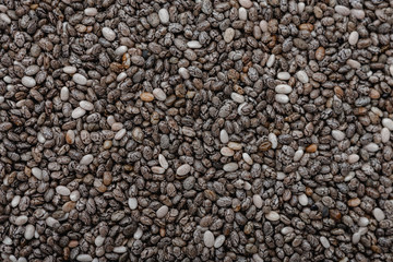 Closeup of dry chia seeds, food background