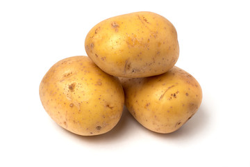Closeup of three fresh natural potatoes, isolated on white background.