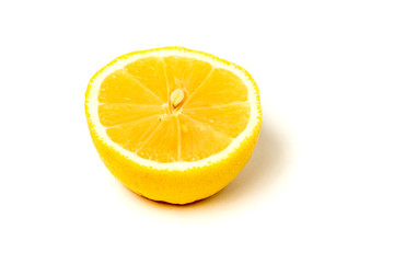 Close-up of a half lemon, with a seed cut in half, isolated on white background.