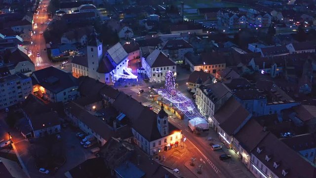 Aerial view of Christmas fair and sparkling decorative lights on main square in Slovenska Bistrica, a small medieval town in Slovenia